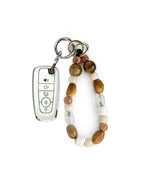 White Ford car key fob cover case with Bohemian and minimalism style agate color beaded wrist strap key chain, displayed on a white background.