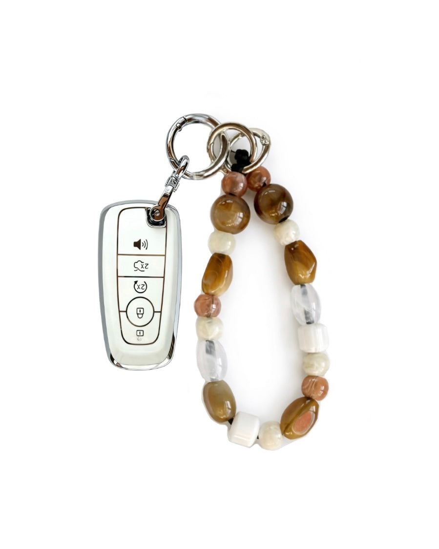 White Ford car key fob cover case with Bohemian and minimalism style agate color beaded wrist strap key chain, displayed on a white background.