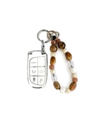 White Jeep car key fob cover case with Bohemian and minimalism style agate color beaded wrist strap key chain, displayed on a white background.
