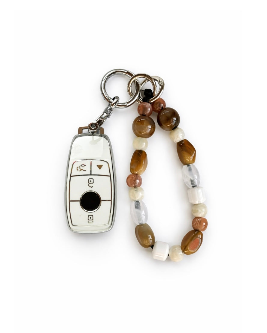 White Mercedes Benz car key fob cover case with Bohemian and minimalism style agate color beaded wrist strap key chain, displayed on a white background.