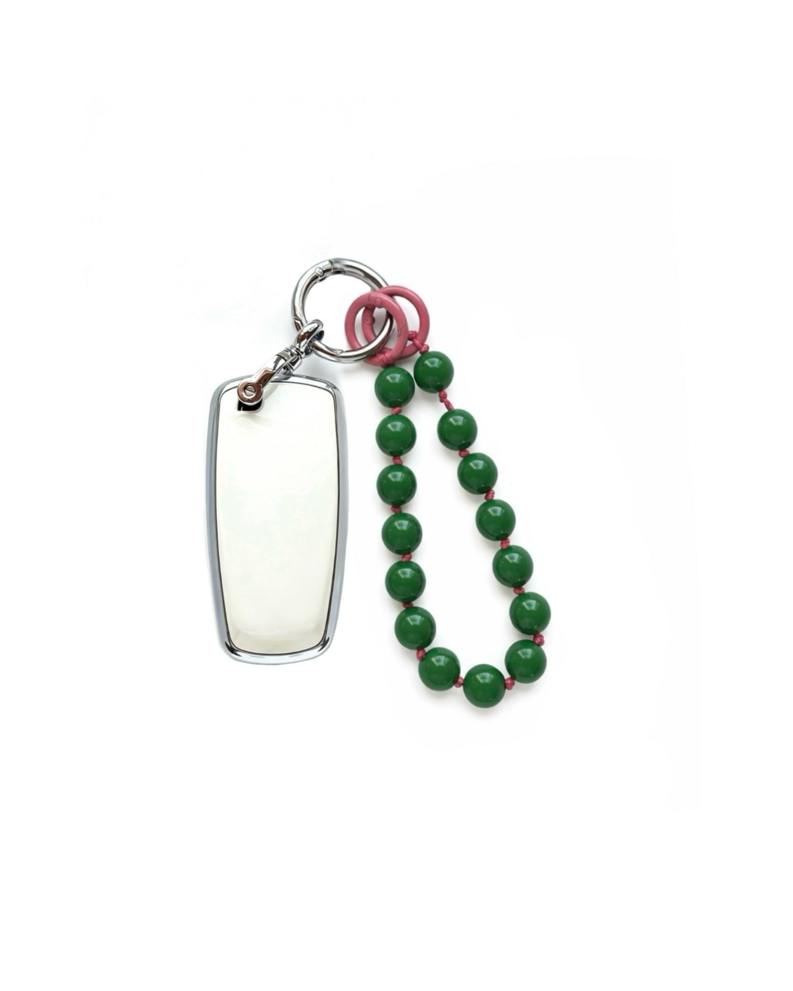 White Ford car key fob cover case, paired with a green beaded on pink wrist strap key chain, displayed on a white background.