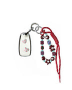White Chevrolet car key fob cover case with pastel plaid heart design, paired with a handmade beaded keychain featuring cute patterned beads, and a red braided cord on a white background.