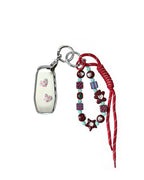 White Ford car key fob cover case with pastel plaid heart design, paired with a handmade beaded keychain featuring cute patterned beads, and a red braided cord on a white background.