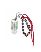 White Hyundai key fob case with pastel plaid heart design, paired with a handmade beaded keychain featuring cute patterned beads, and a red braided cord on a white background.