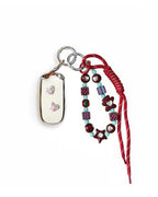 White Jeep car key fob cover case with pastel plaid heart design, paired with a handmade beaded keychain featuring cute patterned beads, and a red braided cord on a white background.
