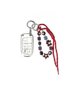 White Jeep car key fob cover case with pastel plaid heart design, paired with a handmade beaded keychain featuring cute patterned beads, and a red braided cord on a white background.