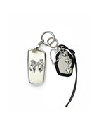 White Bmw key fob case with black mirror and silver bow keychain