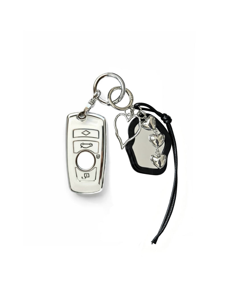White Bmw key fob case with black mirror and silver bow keychain