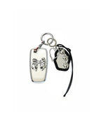 White Ford key fob case with black mirror and silver bow keychain