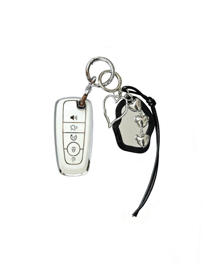 White Ford key fob case with black mirror and silver bow keychain