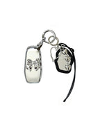 White Ford key fob case with black mirror and silver bow keychain