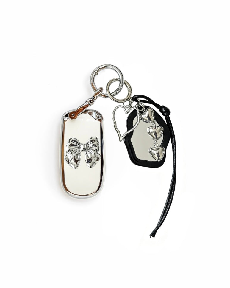 White Jeep key fob case with black mirror and silver bow keychain